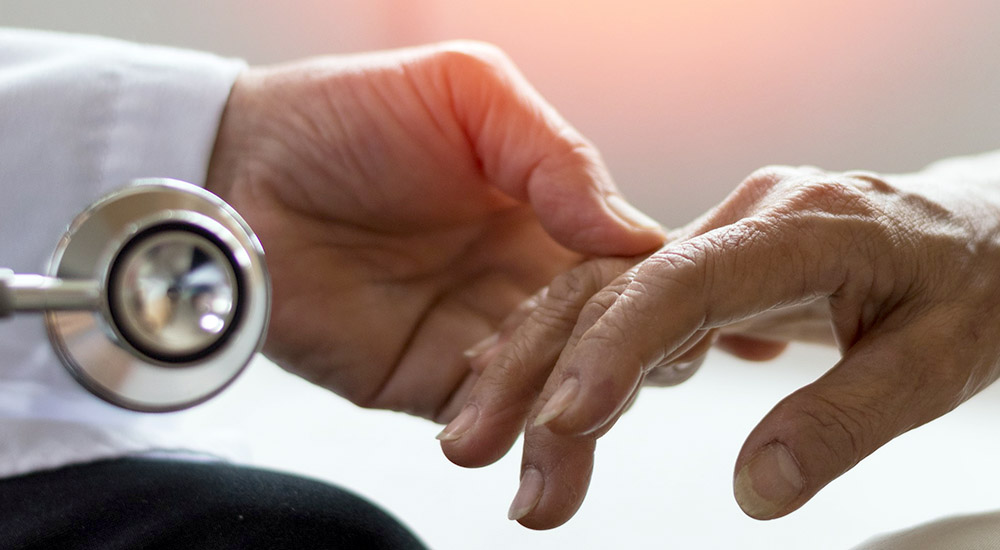 Doctor’s hand holding hand of patient