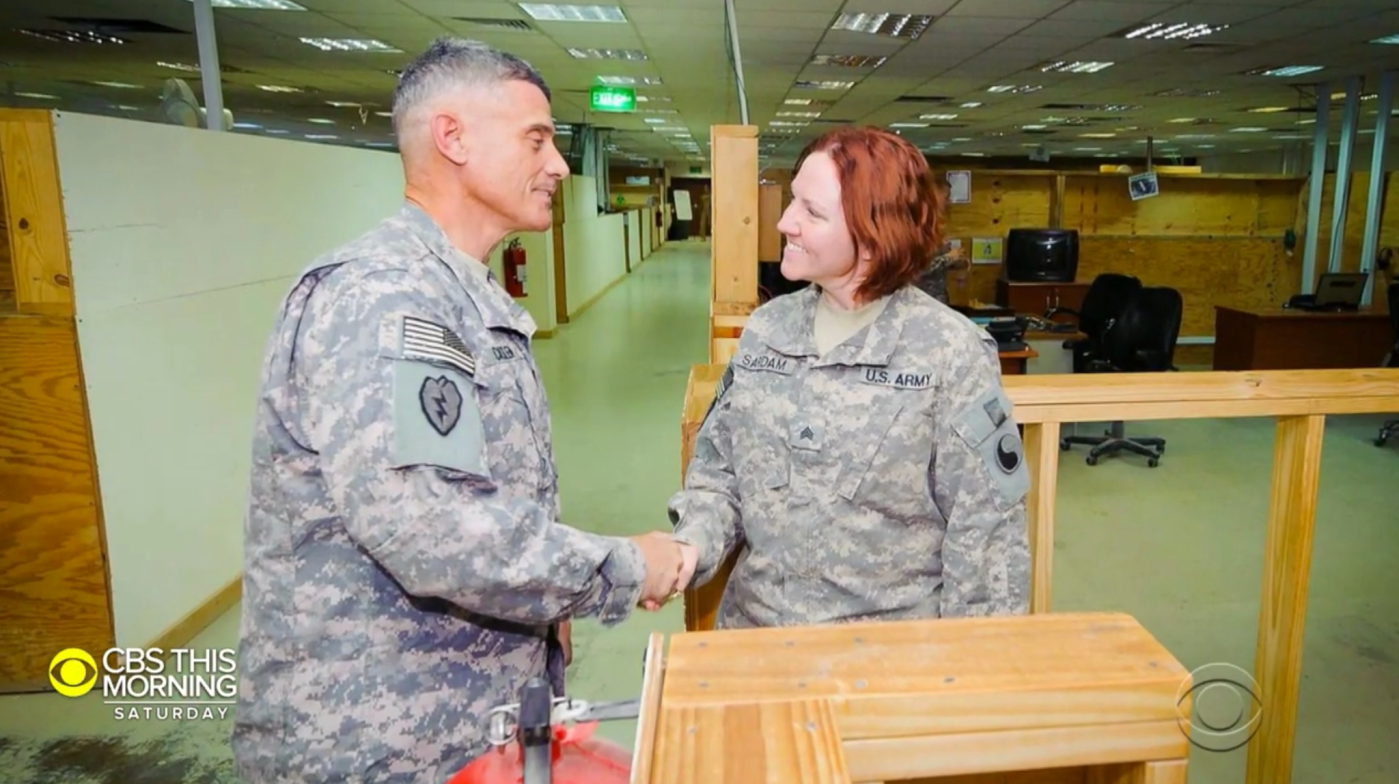 female Veteran shakes hands with male Veteran