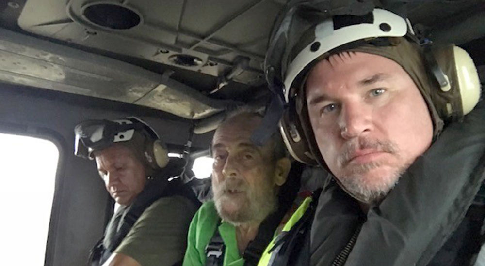 Three men in a Navy helicopter