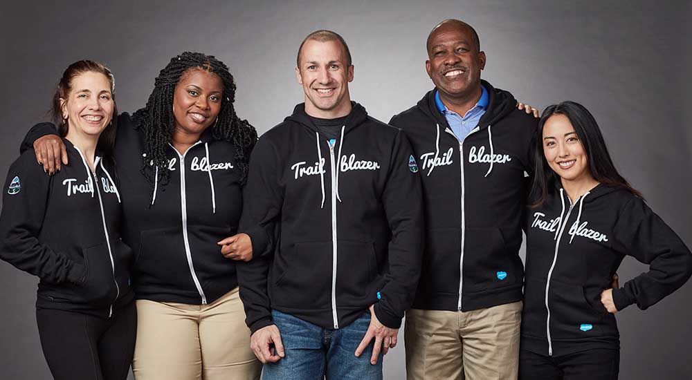 Five people in Trailblazer sweatshirt jackets
