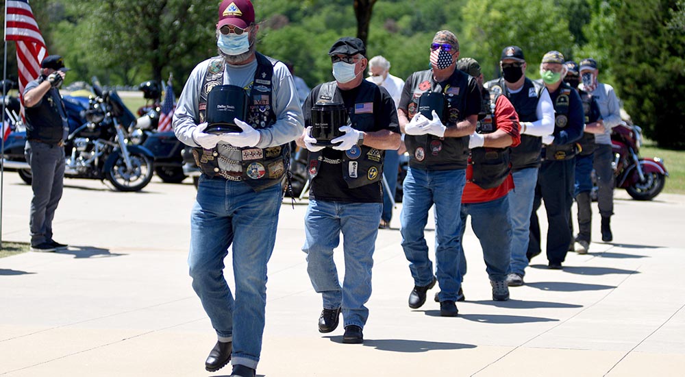 Line of men carrying remains of deceased