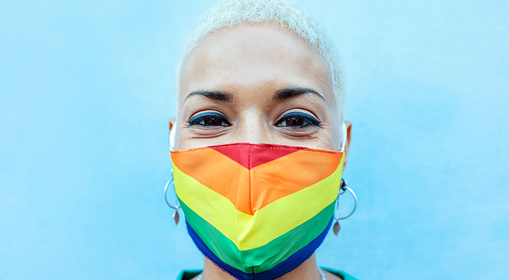 Female Veteran wearing rainbow mask