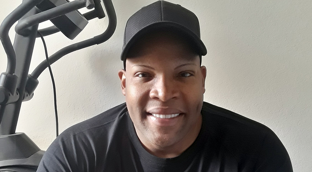 Smiling male Veteran near exercise machine