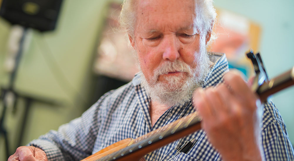 Senior Veteran playing guitar