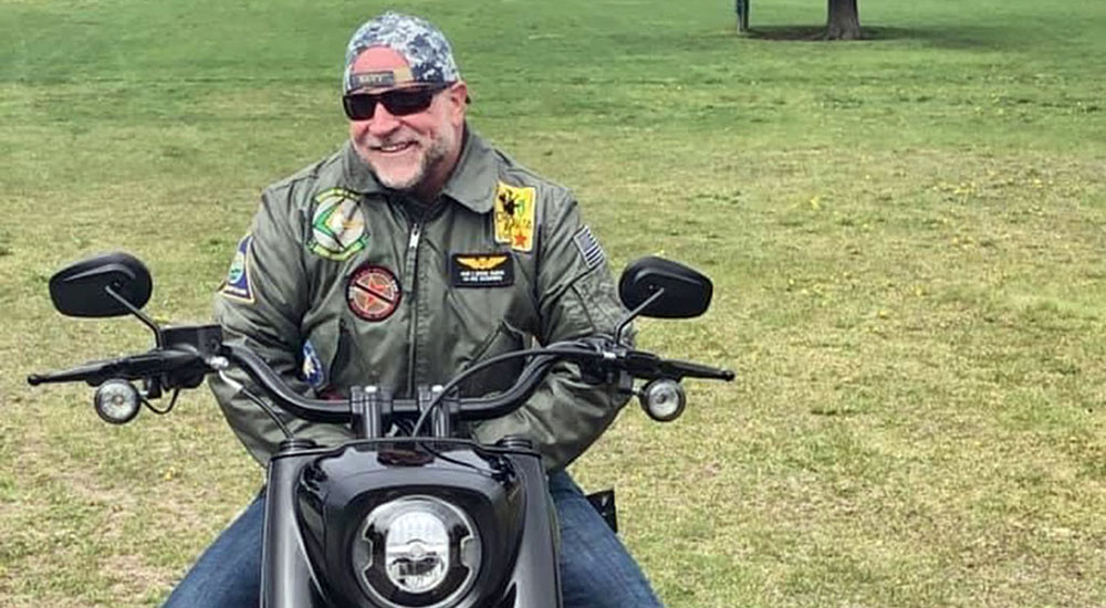 Alaska Navy Veteran who suffers with PTSD sits astride motorcycle