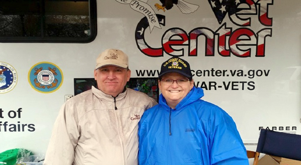 Breast cancer survivor Maureen Heard and her husband in front of a Vet Center van