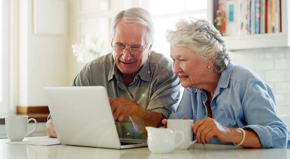 Senior couple reading computer screen