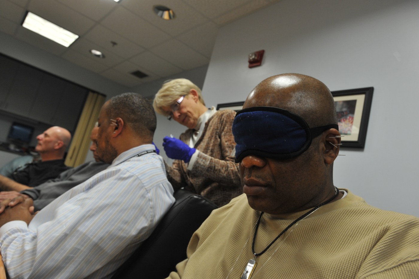 Veterans receive battlefield acupuncture treatment at the Washington DC VA Medical Center. An eye mask and soothing music in the background help create a relaxing environment.