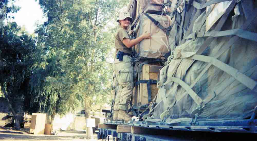 Woman soldier who has MSK loading boxes on truck