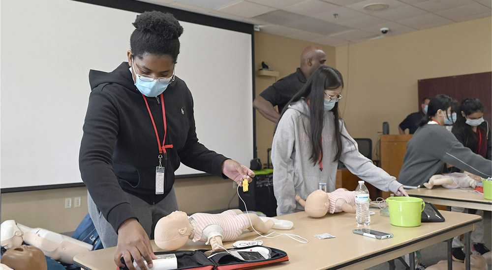 women learning CPR