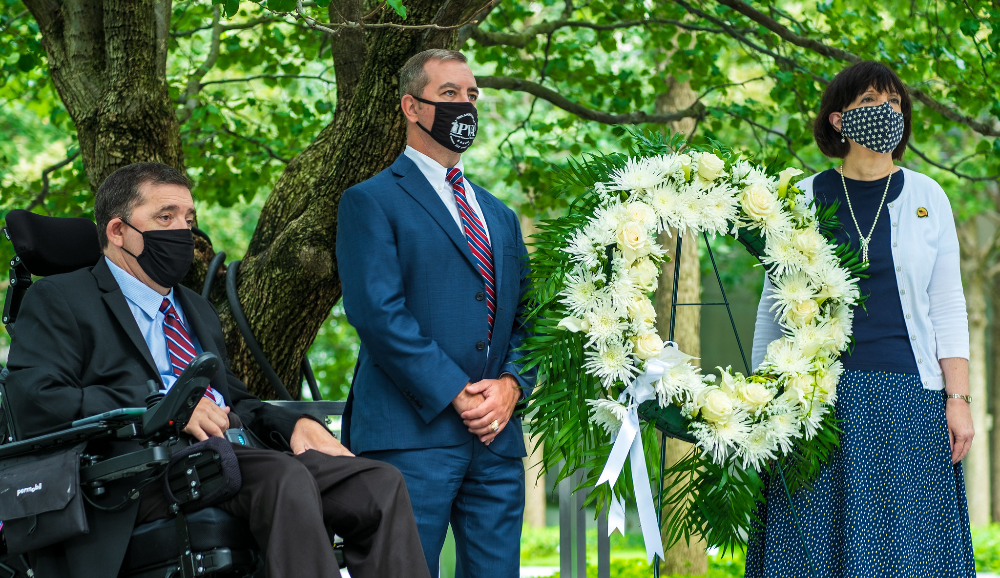 (L-R) Charles Brown, national president of Paralyzed Veterans of America (PVA); PVA executive director Carl Blake; and Martina Parauda, director of the VA NY Harbor Heathcare System, led a wreath-laying ceremony at the 9/11 memorial during the week of the National Veterans Wheelchair Games. VA and PVA co-presented the games.