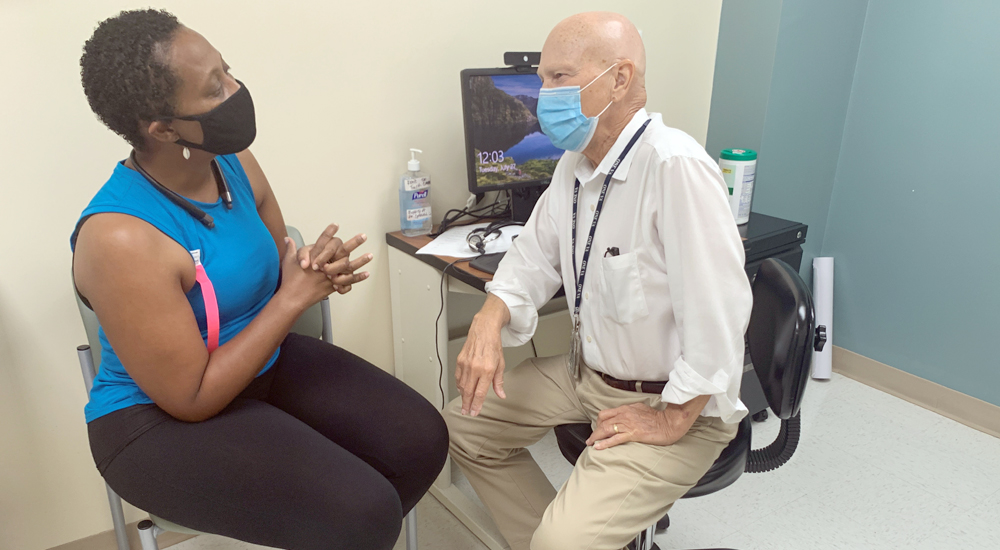 Woman participant in the Breast Cancer Survivorship program talks with her male doctor