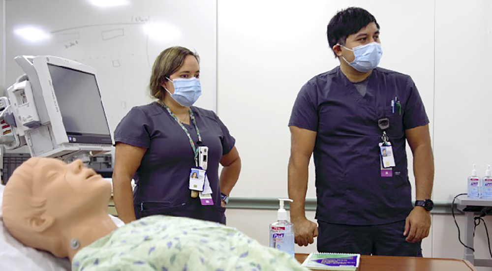 Two ER nurses and mannikin in simulation room