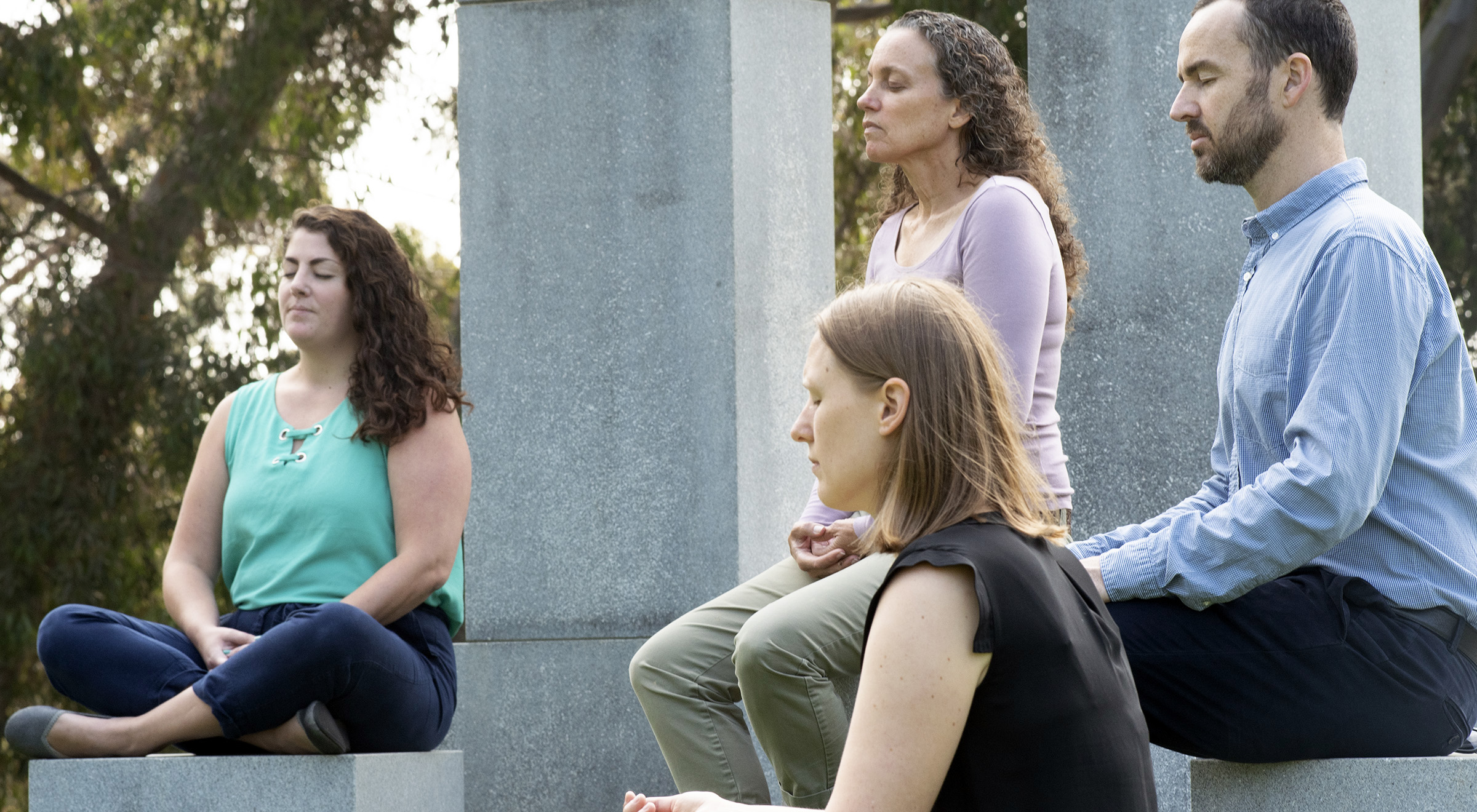 Four people enjoying loving kindness meditation