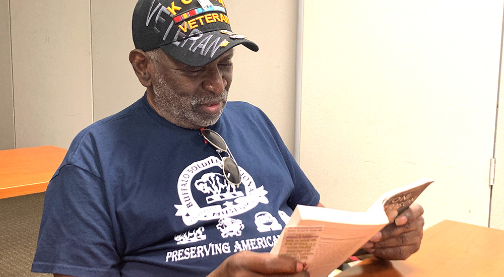 Veteran reading a hardcover book
