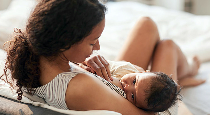 Woman breastfeeding her infant, lactation