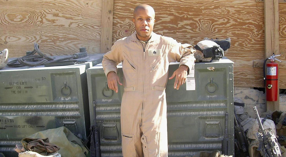 Veteran standing with shipping crates