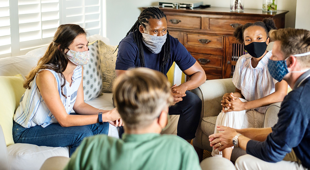 Several people in group residential therapy sitting in a circle