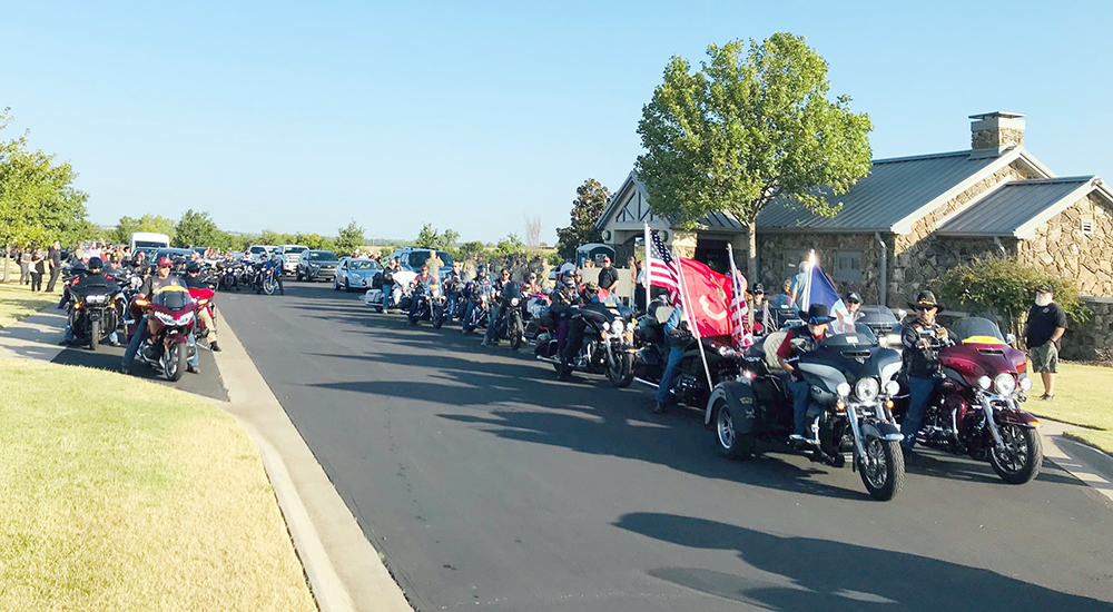 Long line of motorcyclists in a column