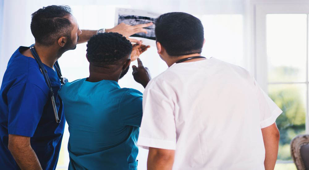 Three people looking at a map on National Rural Health Day