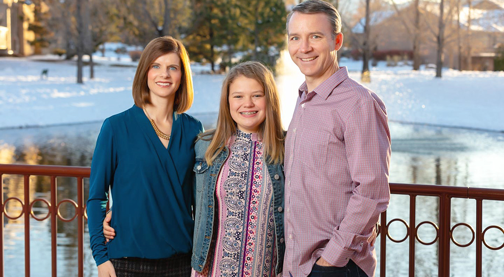 Family photo of West Point graduate, her husband and daughter