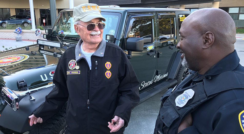 Veteran Rex Gruber talks with a VA policeman
