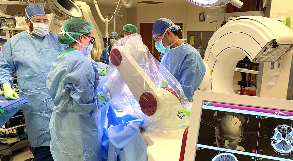 Surgeons in operating room using ROSA surgical device