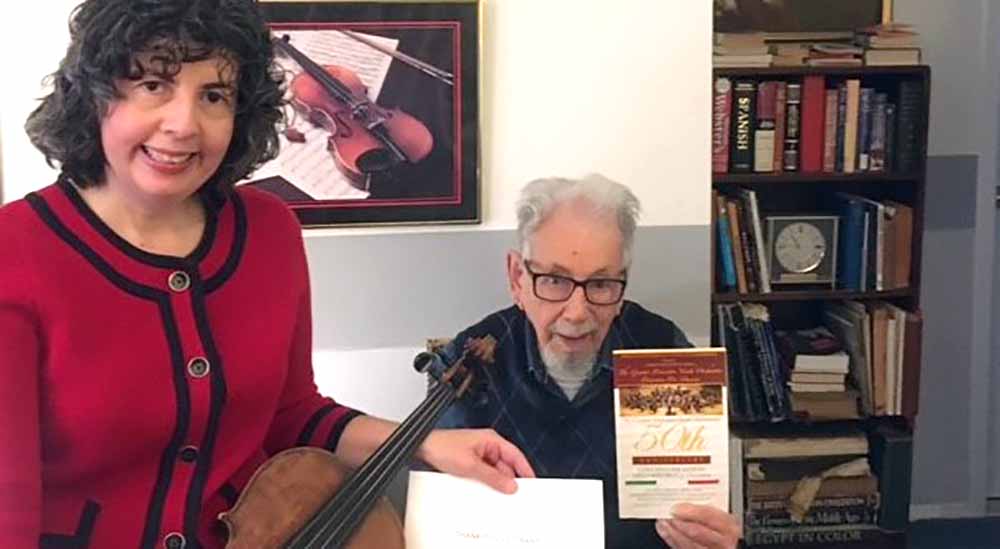 Dr. Mary Rorro and senior Veteran with music score for special song