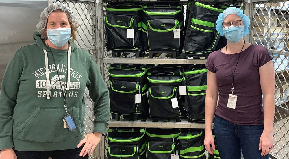 Two women and portable coolers