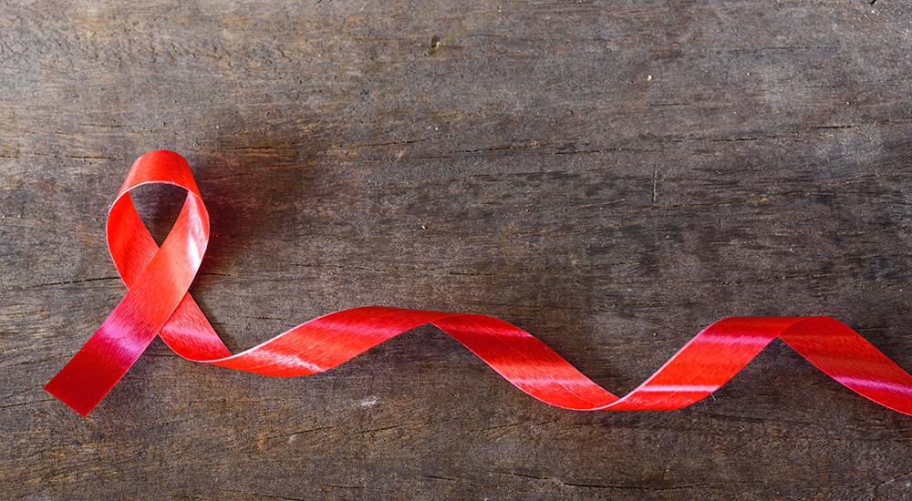 A twisted red ribbon symbolizing HIV and AIDS awareness