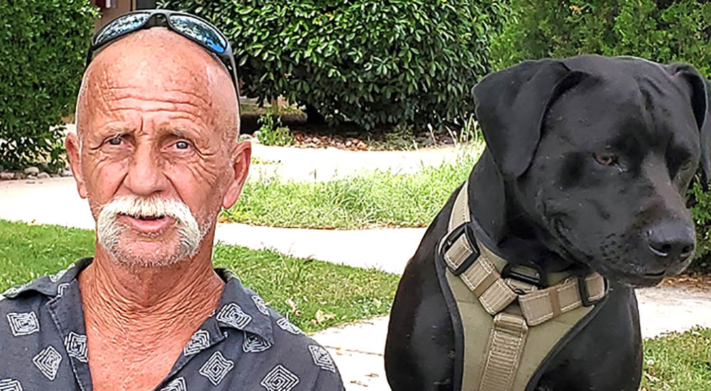 Previously homeless Veteran and his dog in a park