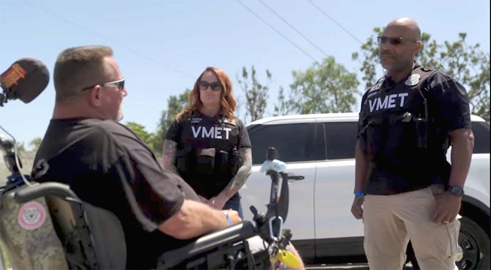 Two innovation revolutionary VA employees assisting a Veteran in a wheelchair
