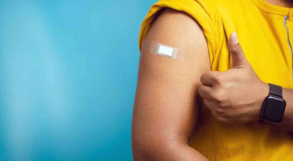 Bandage on arm covering flu shot site
