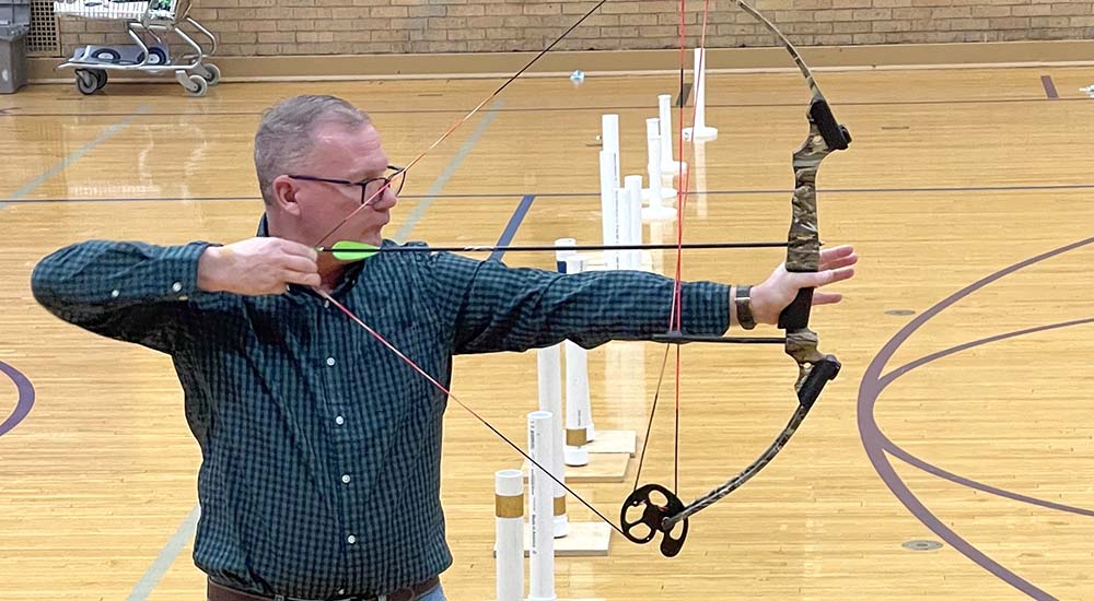 Man with Multiple Sclerosis using bow and arrow