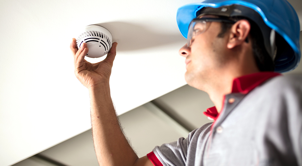 A man installing carbon monoxide alarm
