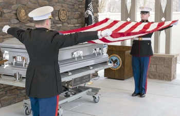 Honor guard folds funeral flag