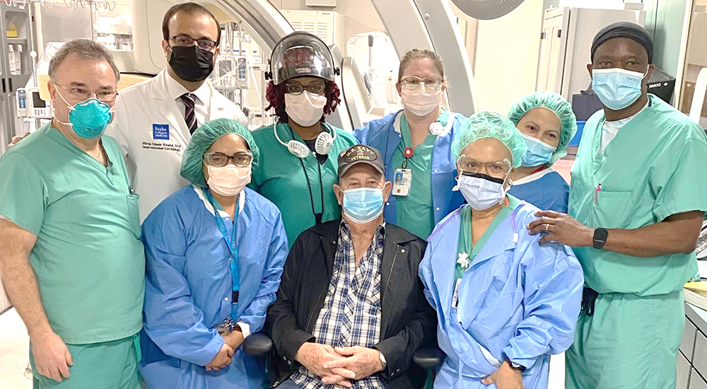 Veteran heart patient and seven members of the VA clinical team
