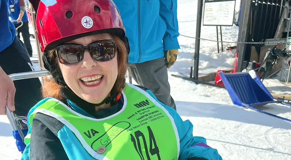 Veteran grins after her Winter Clinic first run in a bi-ski