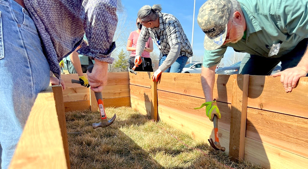 Workers building raised garden beds