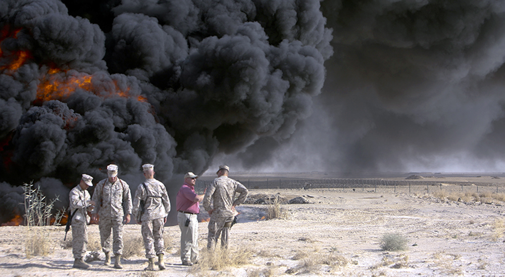 Soldiers at large clouds of black smoke of burn pit, creating possible airborne hazards