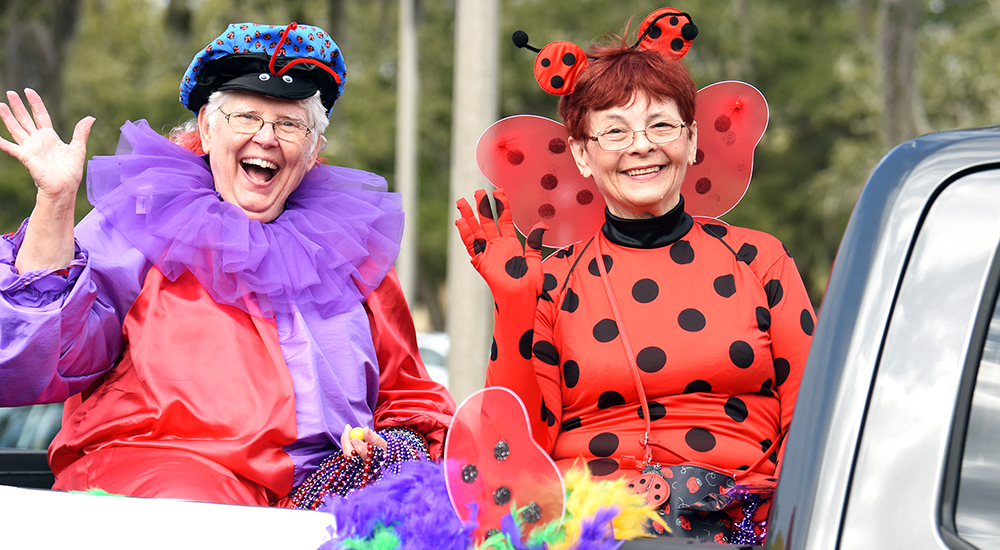 Two ladies in costume in Mardi Gras parade