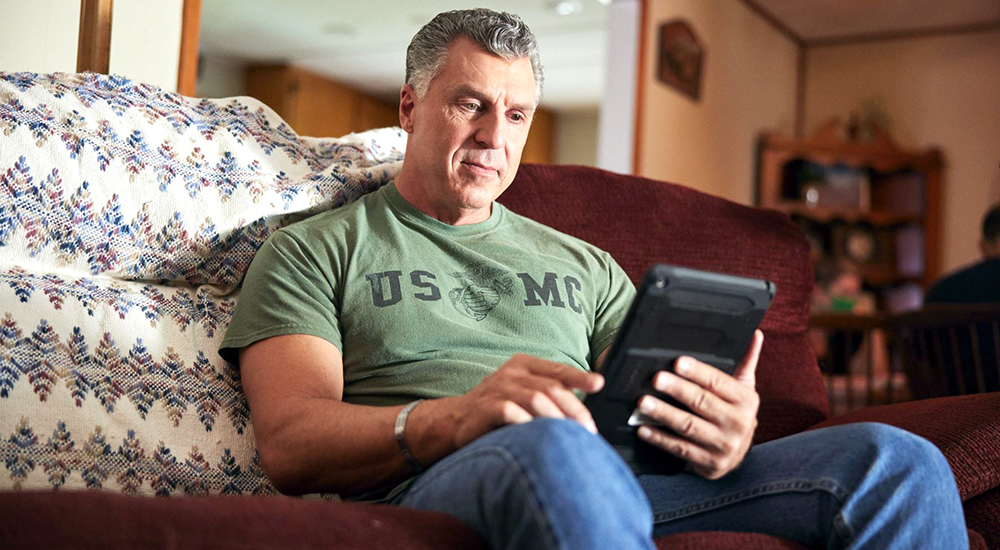 Marine Corps Veteran uses a tablet to access VA virtual care.