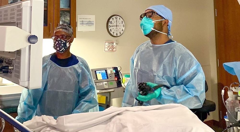 Doctor and nurse wearing scrubs in operating room