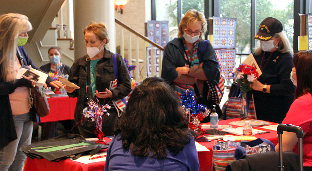 Texas women collect material at information table