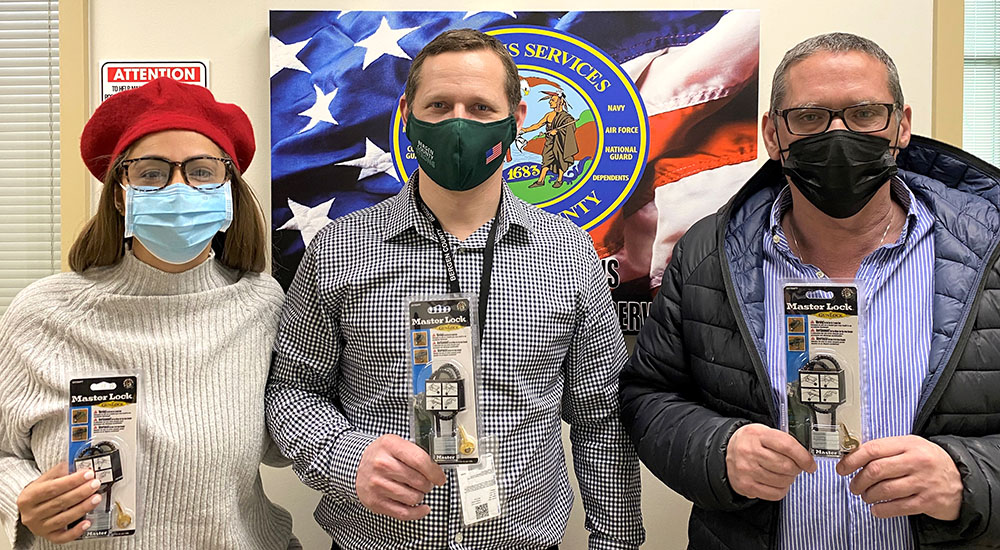 Three people holding up gun locks