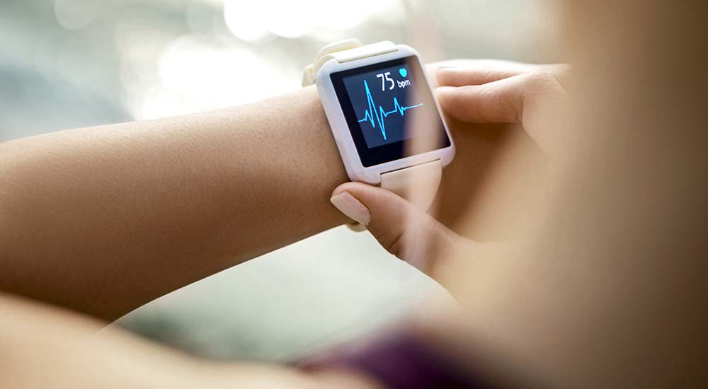 Mobile health device on person’s wrist displays heart rate