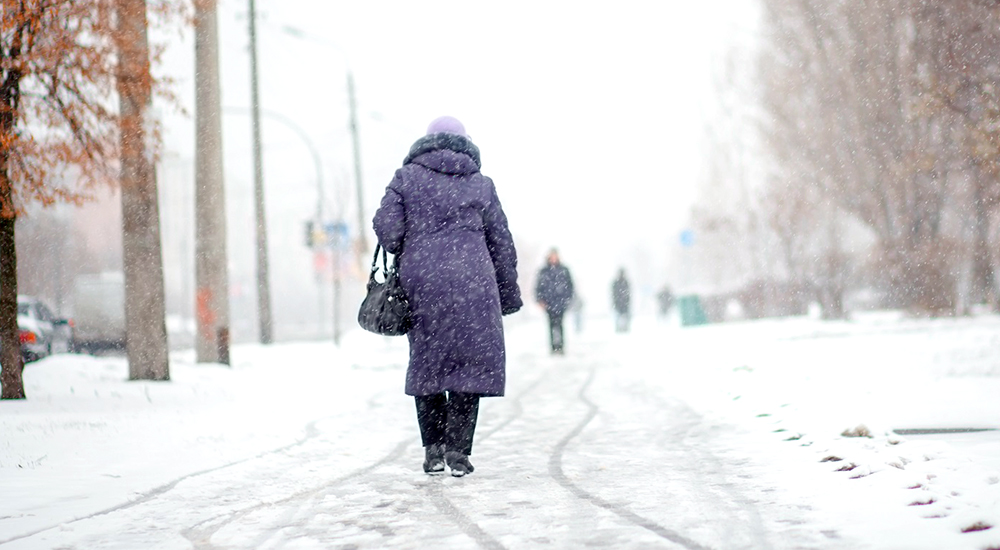 Woman walking in snowy weather in Buffalo