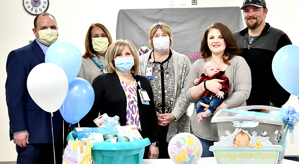 Group of people with mom and dad and newborn baby