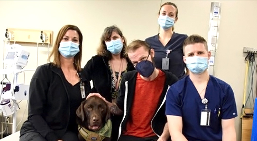 Four clinicians, a patient, and a dog
