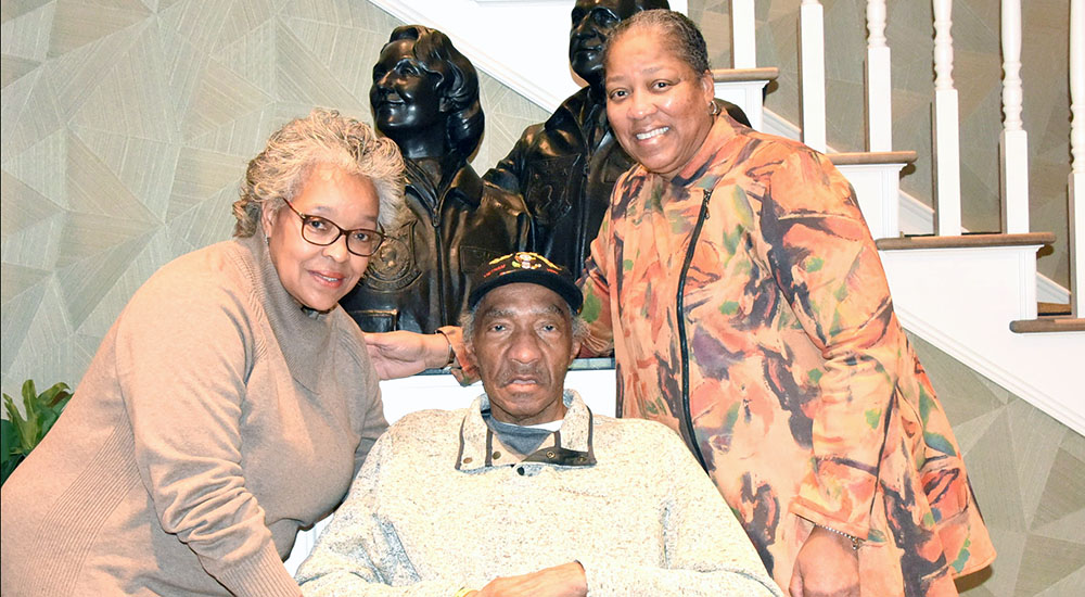 A Veteran and two ladies in Fisher House lobby
